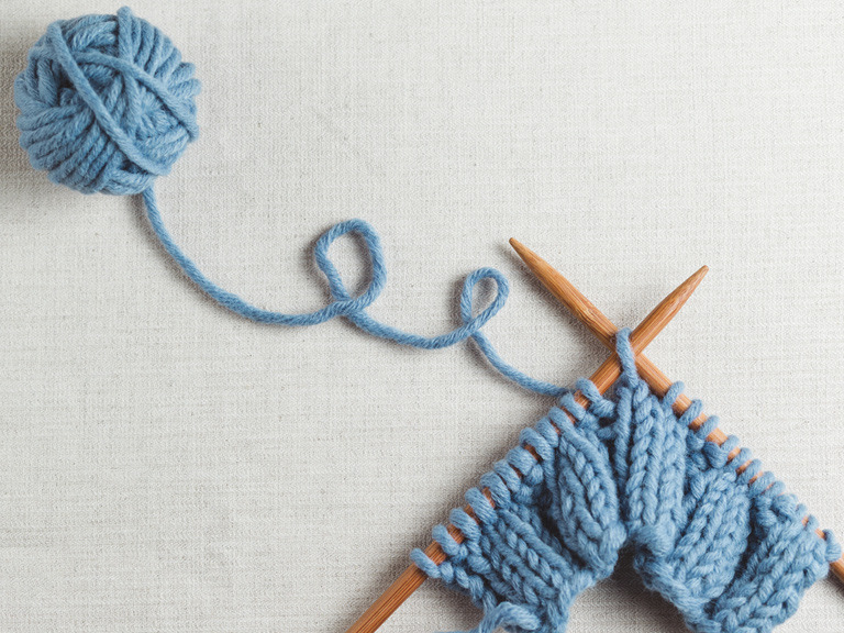 Blue yarn and knitting needles 
