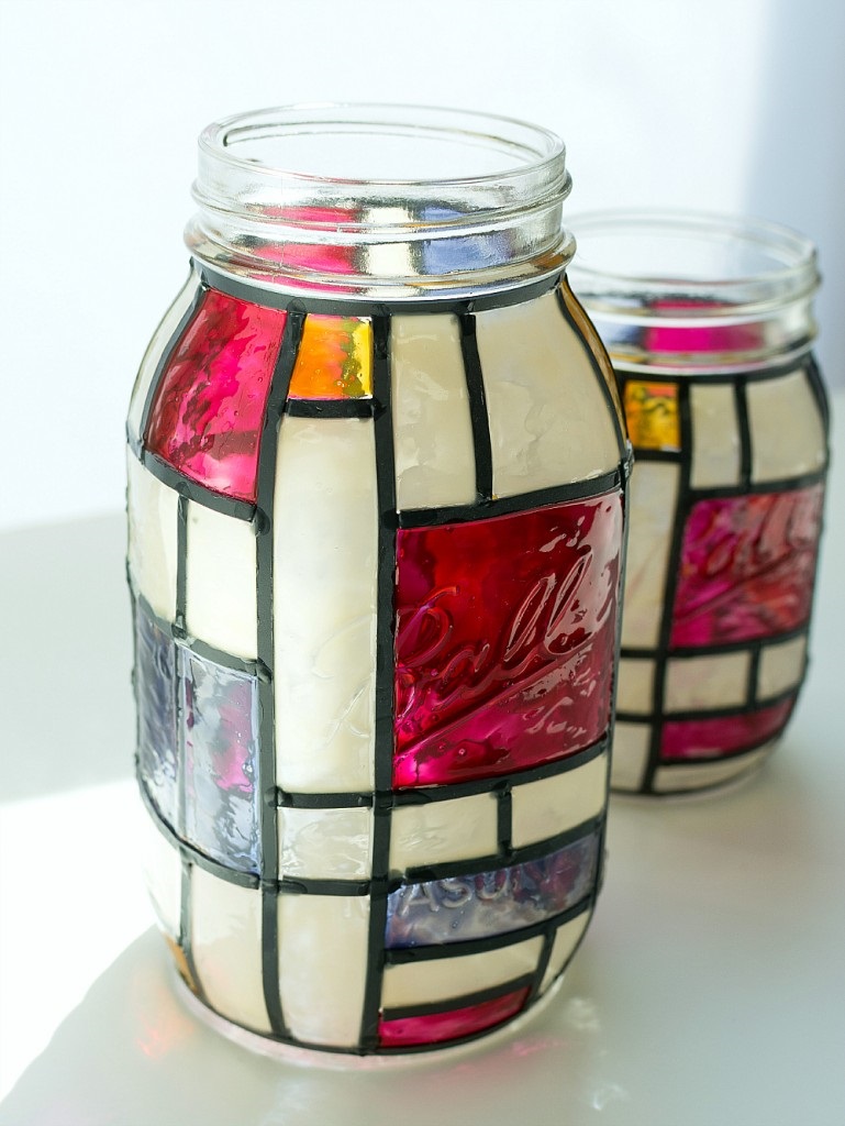 Mason jar with white, yellow, red, and blue geometric shapes 