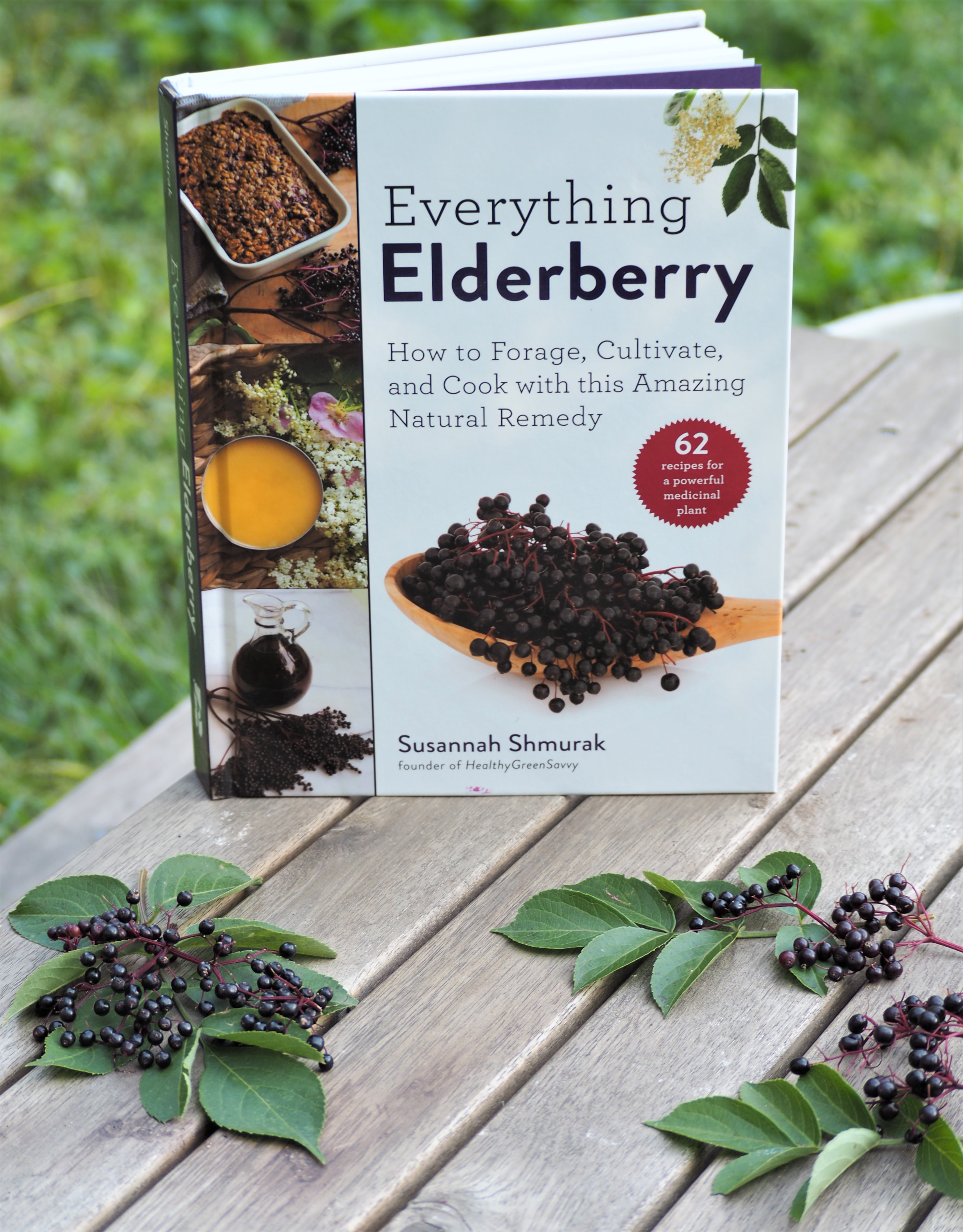 Book with elderberries on table