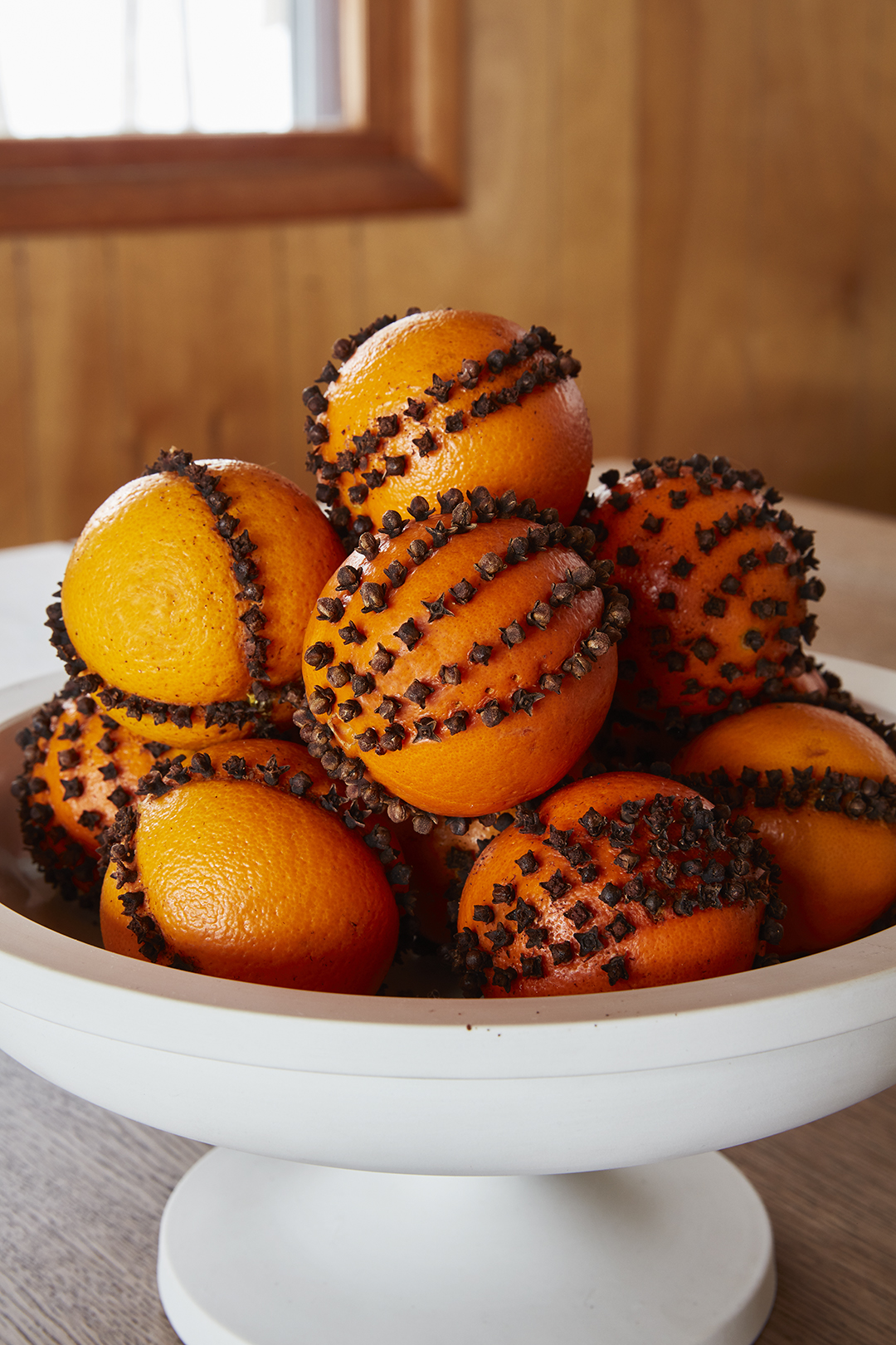 festive oranges with cloves arranged in bowl