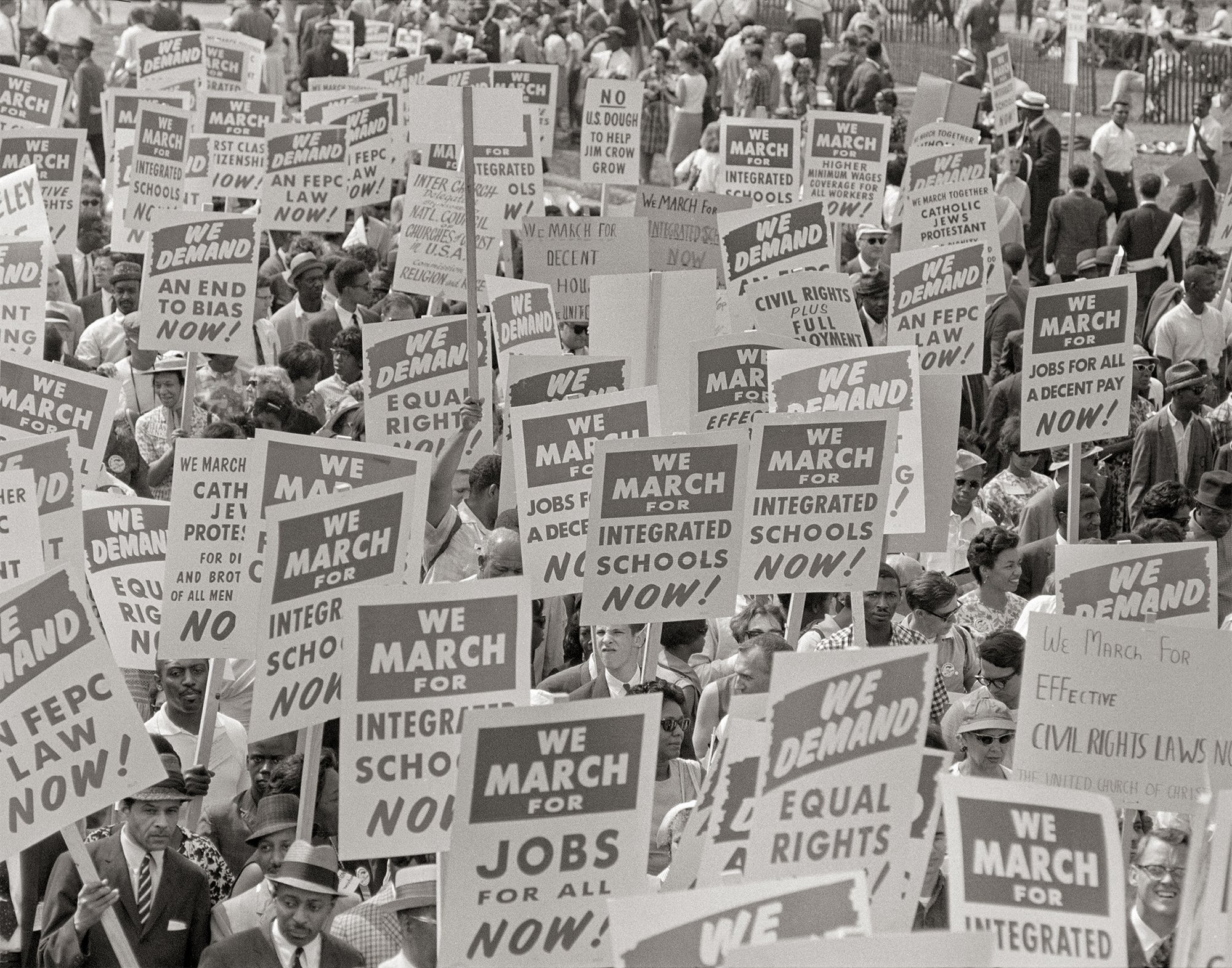 black and white photo of crowd with signs