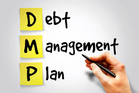 Whiteboard with "Debt Management Plan" written on it 